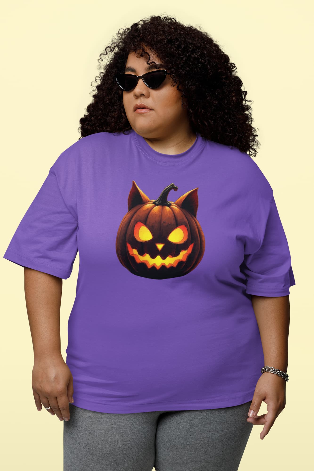 Model wearing unisex premium Cat-O’-Lantern Tomcat t-shirt with spooky and playful Halloween pumpkin cat design