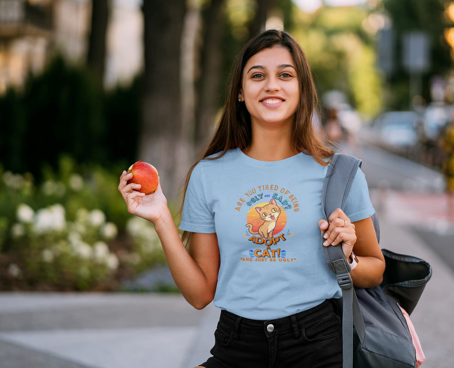 Model wearing Funny Sarcastic Cat vintage graphic tee with humorous slogan Adopt a Cat and Just Be Ugly