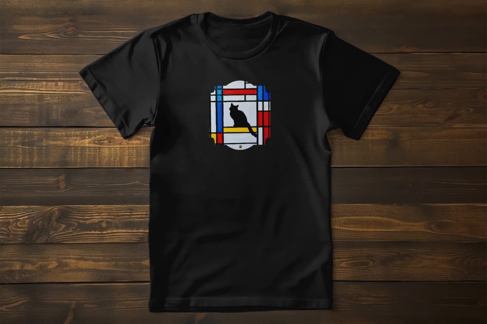 Flat lay of Meowdrian unisex premium cat t-shirt featuring Mondrian style geometric red, blue, yellow blocks with cat illustration