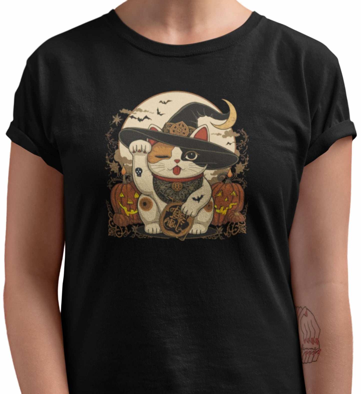 Close-up of Witchy Neko cat t-shirt print showing whimsical Maneki-neko with witch hat, candles, celestial symbols, and warm vintage colors