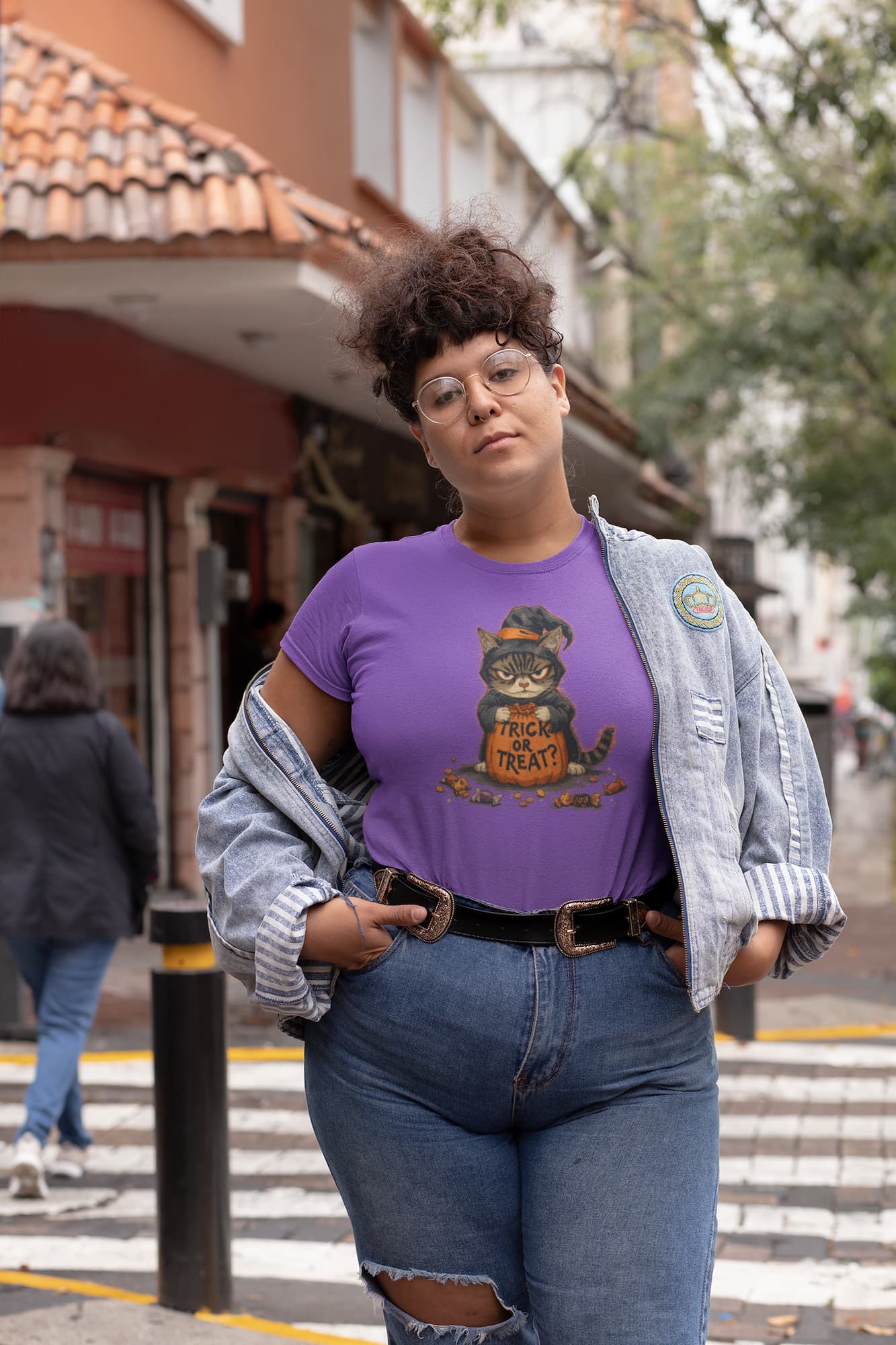 Mockup of unisex premium Trick or Treat Cat Halloween t-shirt with vintage ghostly black cat holding sack of candy design