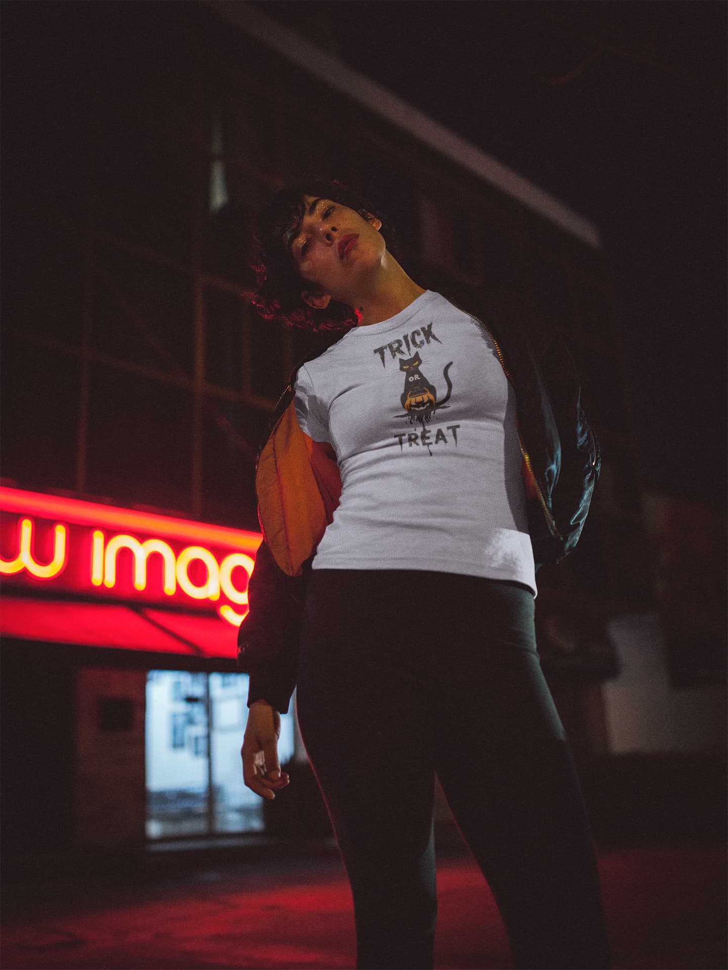 Model wearing No Candy No Mercy unisex premium Halloween t-shirt with sleek black and orange minimalist cat design