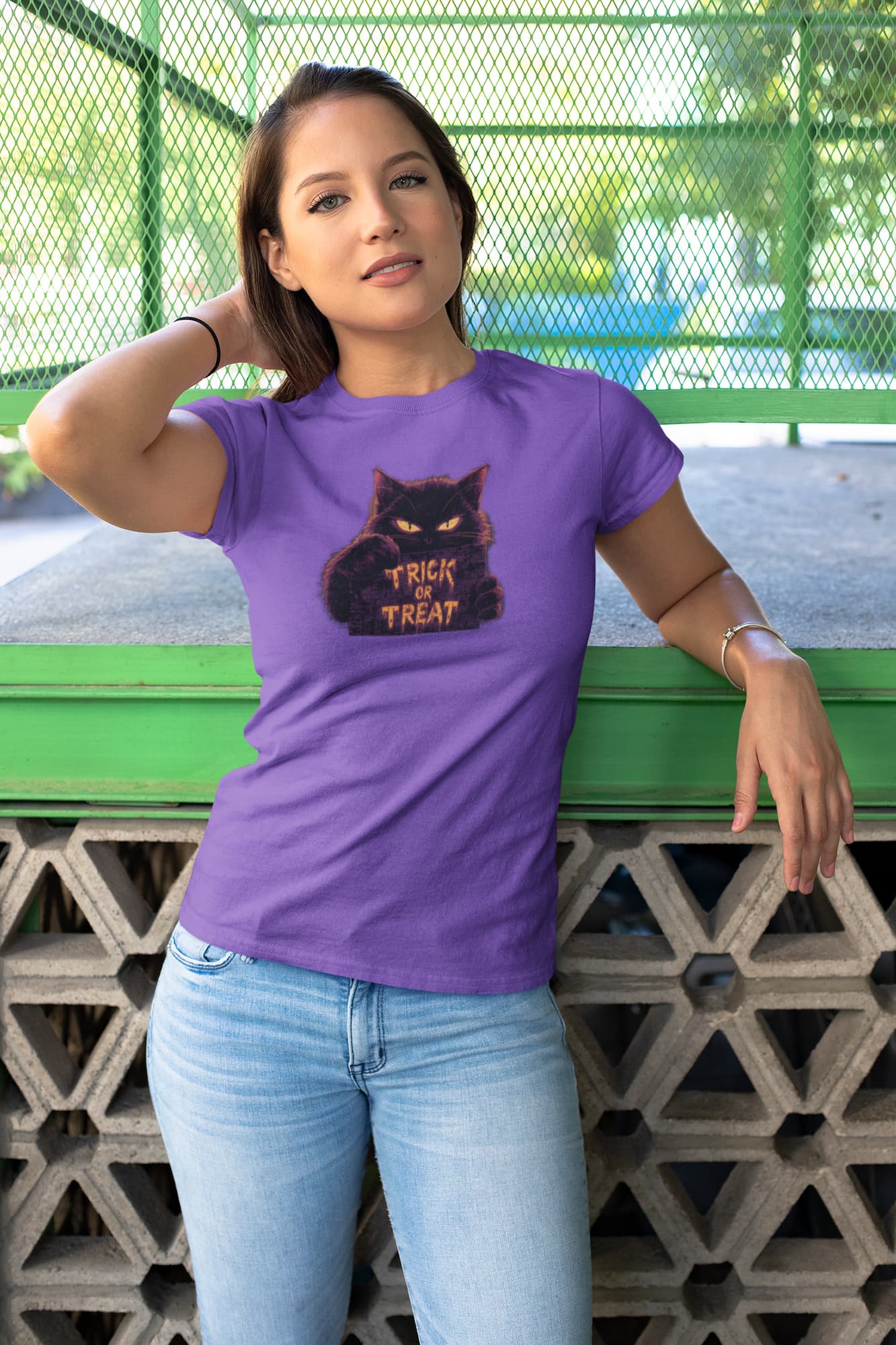 Model wearing Cursed Candy unisex premium Halloween cat t-shirt with minimalist glowing Trick or Treat sign and mysterious feline eyes