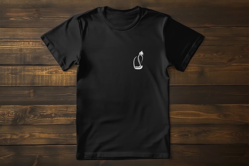 Flat lay of Noir Paws premium unisex t-shirt featuring elegant black cat artwork