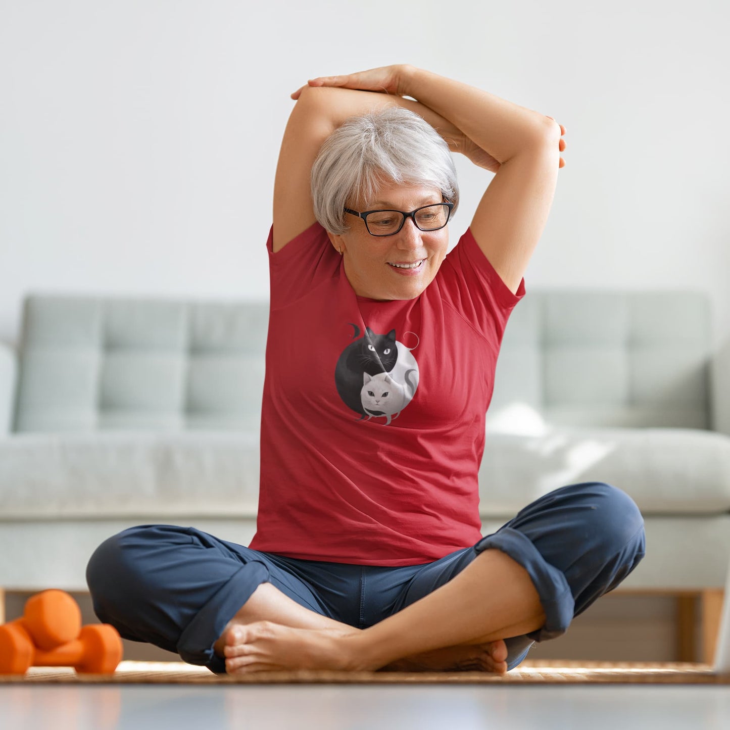 Model wearing Yin Yang Cat t-shirt with playful philosophical design of balanced cats