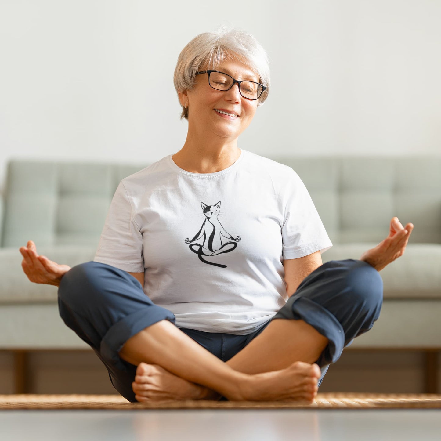 Model wearing Padmasana Yoga Cat t-shirt with minimalist yoga cat design in lotus position