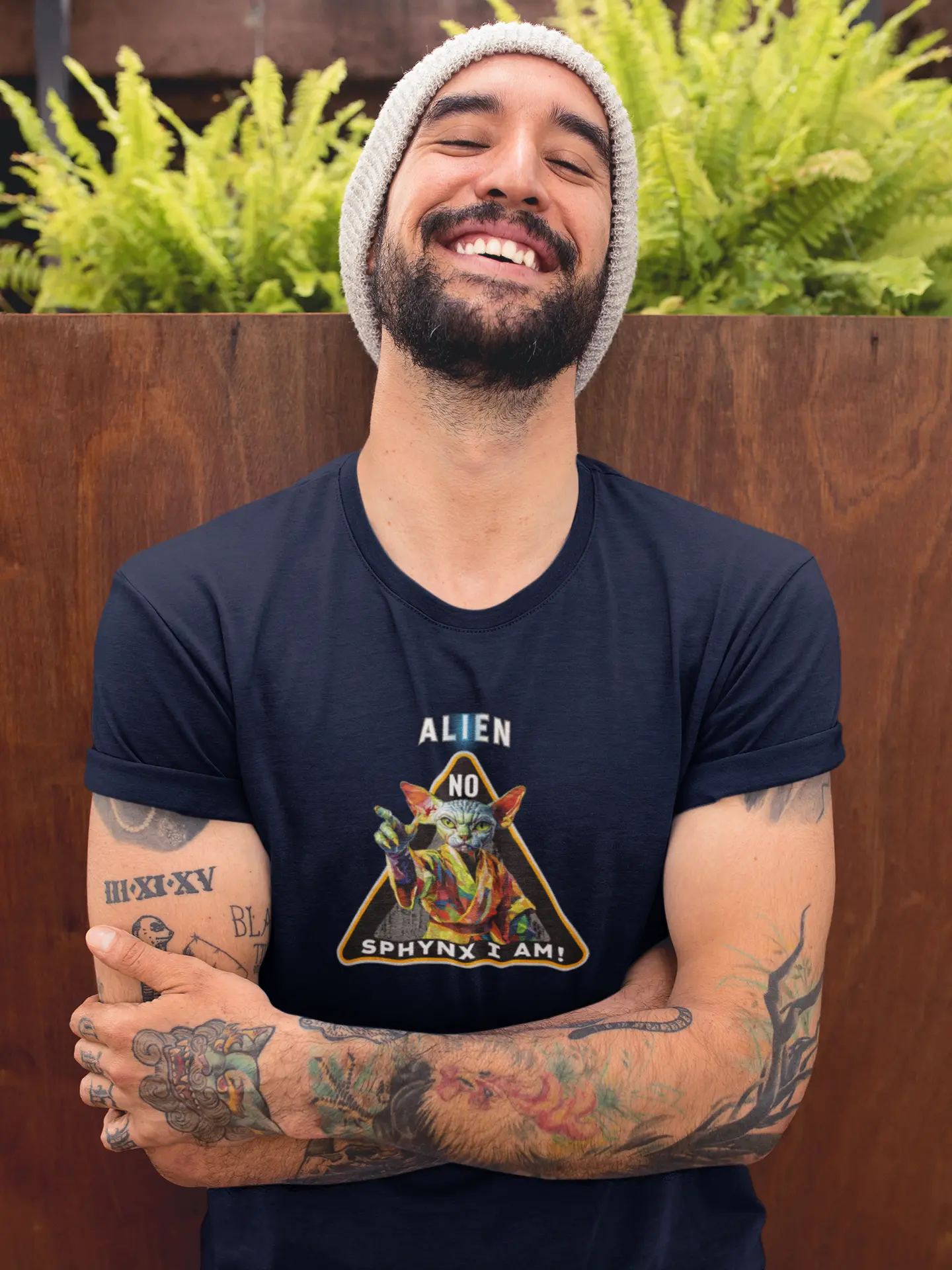 Model wearing the 'I Am Sphynx, Not Alien - The Galactic Hairless’ T-shirt with a sci-fi inspired Sphynx cat design, radiating humor, mystery, and nerdy feline attitude.
