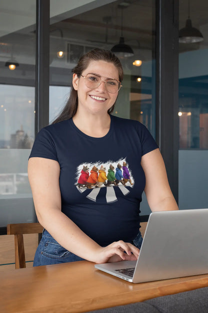Model wearing Here Come the Cats T-Shirt – unisex premium tee featuring six stylish cats walking across an Abbey Road-inspired crosswalk.