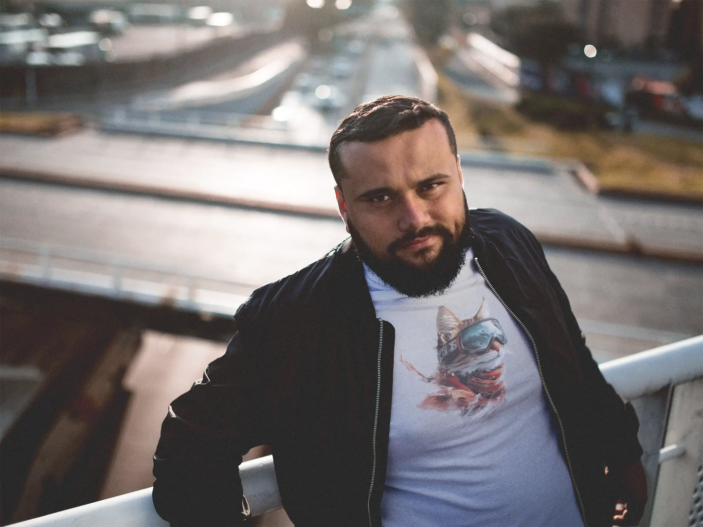 Person wearing Snowcat Vision Winter Cat T-Shirt in a snowy city scene – stylish unisex tee for cat fans and winter fashion lovers.