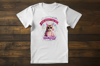 Flat lay of the 'Gamer Cat: What Doesn’t Kill You Gives You XP!' T-shirt displaying the illustrated gamer cat and XP-inspired typography.