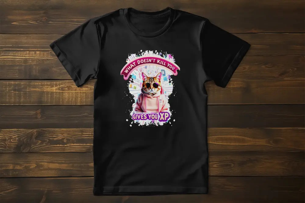 Flat lay of the 'Gamer Cat: What Doesn’t Kill You Gives You XP!' T-shirt displaying the illustrated gamer cat and XP-inspired typography.