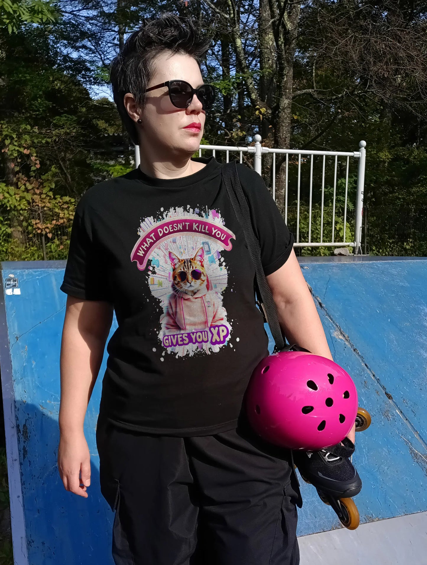 Mockup of the 'Gamer Cat: What Doesn’t Kill You Gives You XP!' T-shirt featuring a confident gaming cat with a bold gamer-style quote.