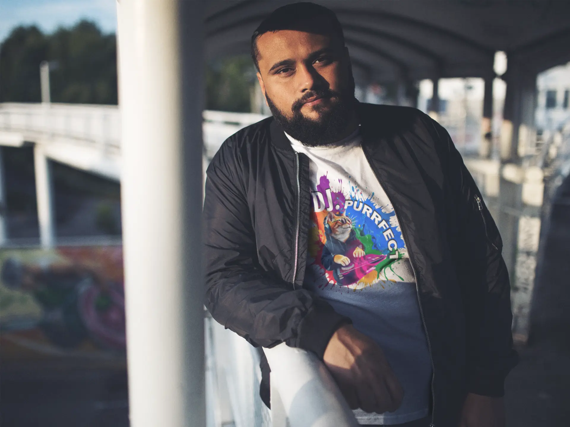 Person wearing Beat Maker Cat unisex T-shirt at music event – stylish cat lover tee with colorful DJ design and pride-inspired vibes.