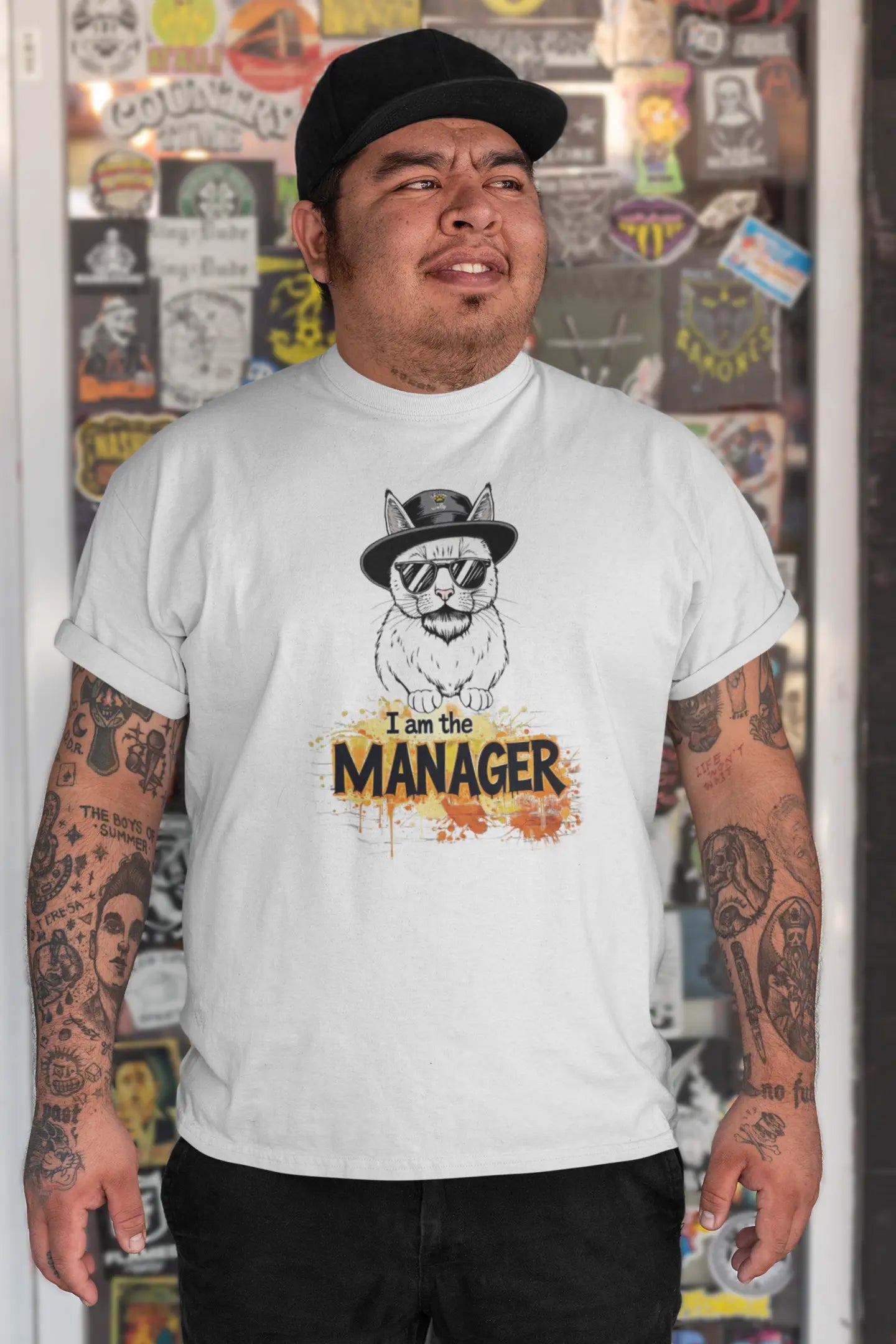 Model wearing I Am the Maneger T-Shirt – unisex premium tee featuring a minimalist cat with sunglasses, beard, and hat inspired by pop culture icons.