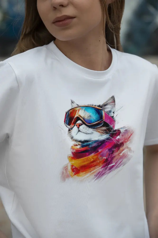 Model wearing Pink Snow Winter Cat T-Shirt – unisex premium tee featuring a chic cat with ski goggles and snowy mountain reflection.