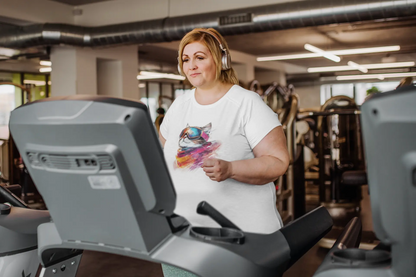 Model wearing Pink Snow Winter Cat T-Shirt – unisex premium tee featuring a chic cat with ski goggles and snowy mountain reflection.