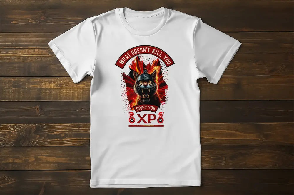 Black t-shirt laid flat or on a hanger, fully displaying the print of a warrior cat with a Spartan helmet, bared fangs, and intense flames. Print reads "What Doesn't Kill You Gives You XP".