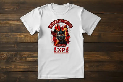 Black t-shirt laid flat or on a hanger, fully displaying the print of a warrior cat with a Spartan helmet, bared fangs, and intense flames. Print reads "What Doesn't Kill You Gives You XP".