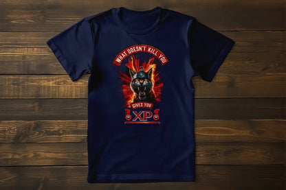 Black t-shirt laid flat or on a hanger, fully displaying the print of a warrior cat with a Spartan helmet, bared fangs, and intense flames. Print reads "What Doesn't Kill You Gives You XP".