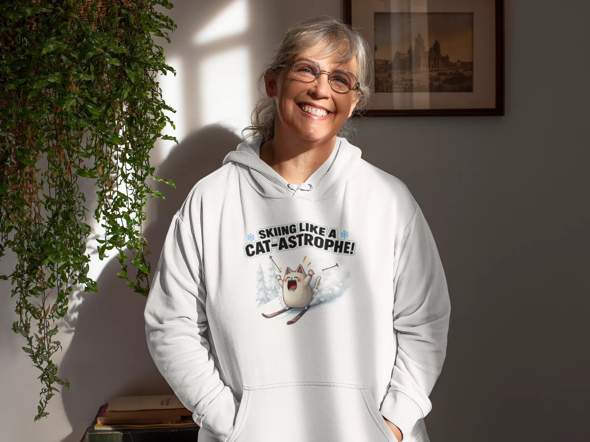 Model wearing Cat-Astrophe Winter Cat Hoodie – unisex premium tee featuring a funny cat tumbling down a snowy mountain with ski poles flying.