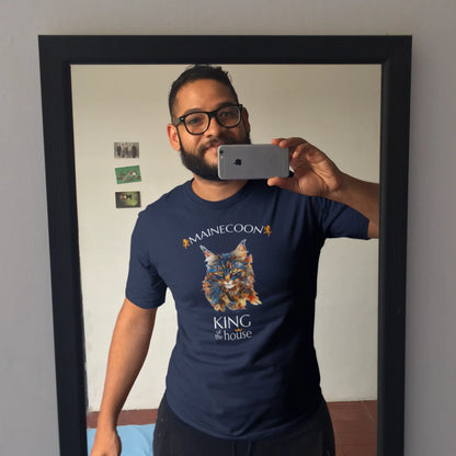 Mockup of the 'King of the House – The Maine Coon Edition' T-shirt featuring a majestic Maine Coon cat illustrated in fragmented abstract style, symbolizing feline royalty.