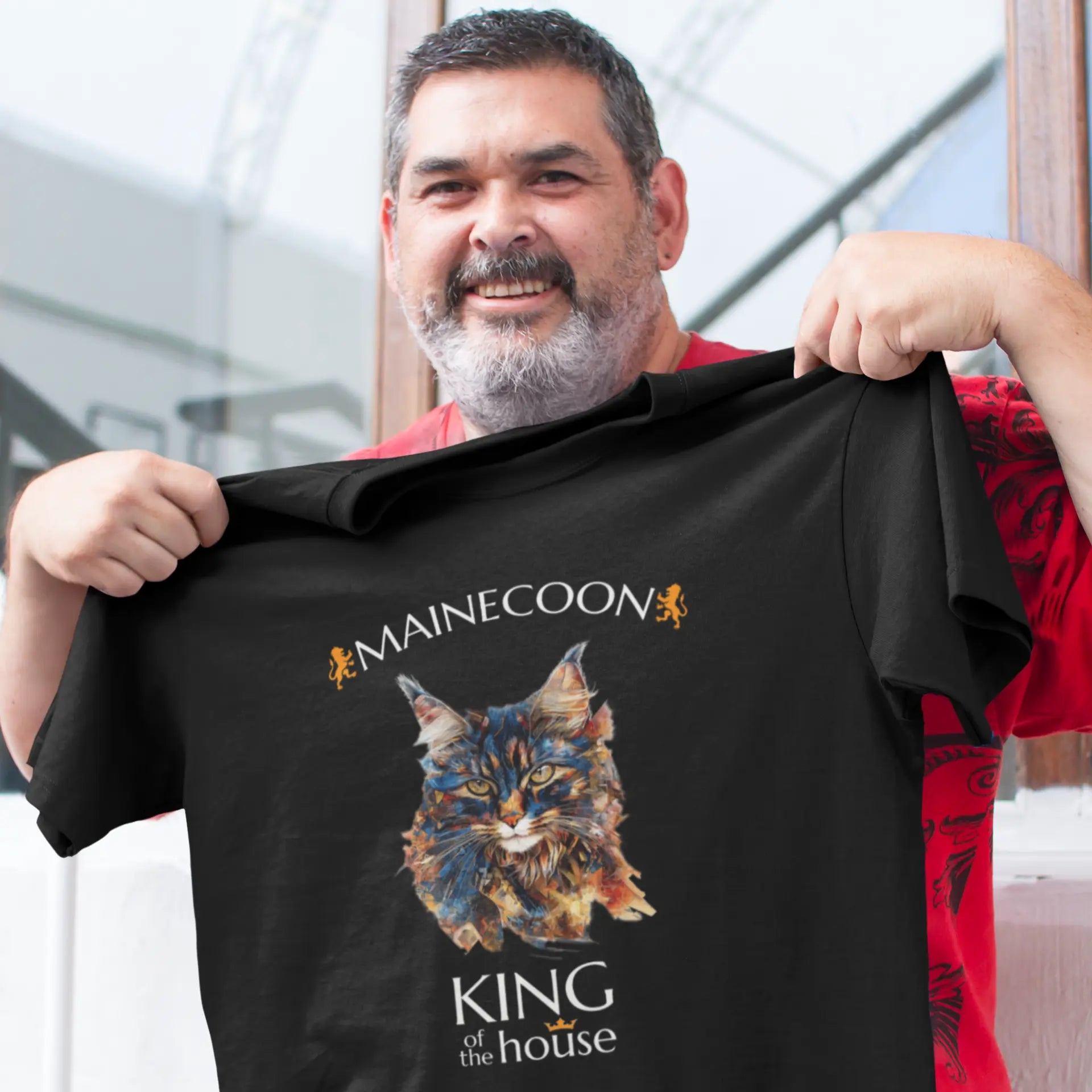 Mockup of the 'King of the House – The Maine Coon Edition' T-shirt featuring a majestic Maine Coon cat illustrated in fragmented abstract style, symbolizing feline royalty.