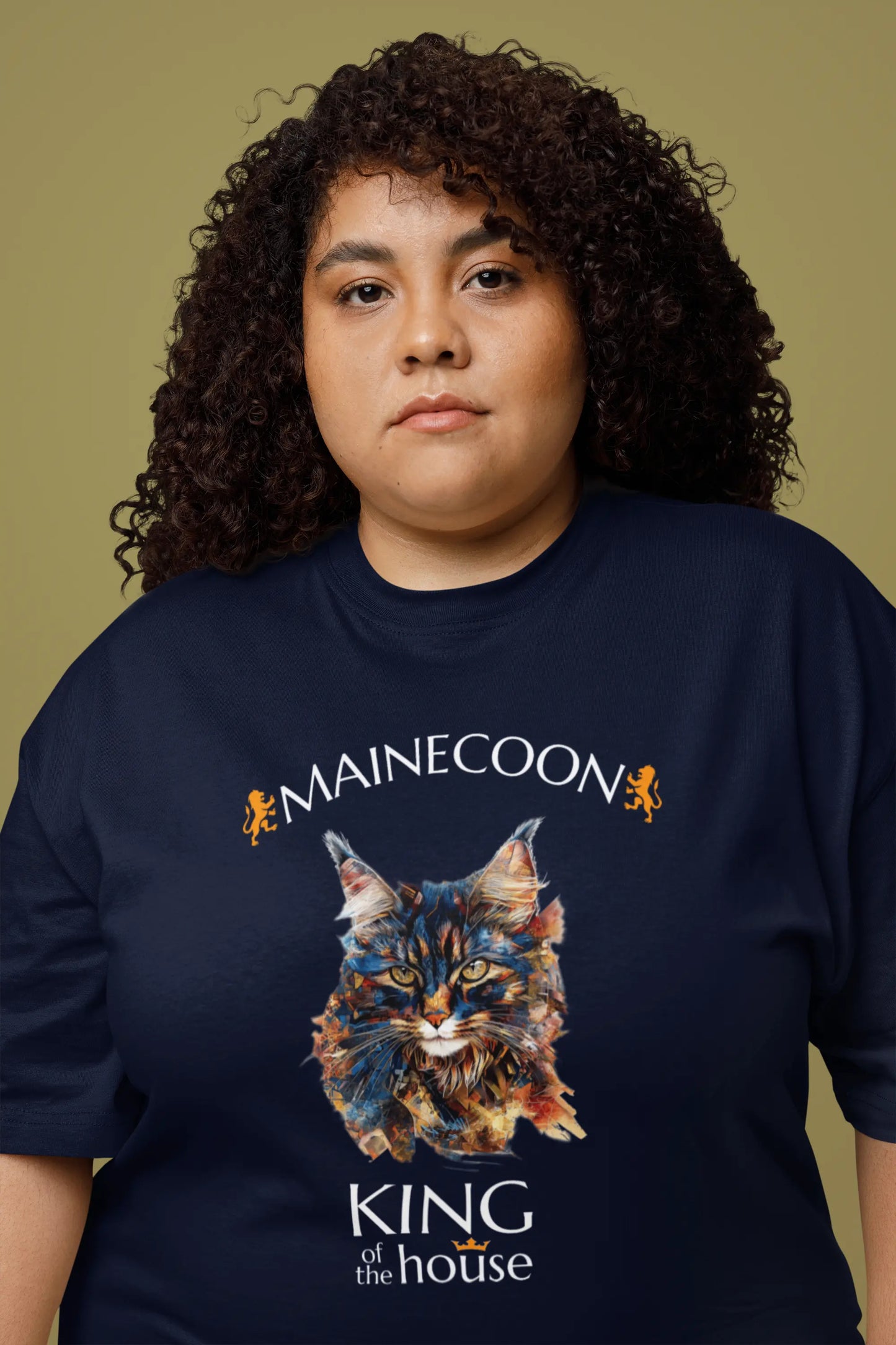Model wearing the 'King of the House – The Maine Coon Edition' T-shirt with a regal abstract Maine Coon cat design, capturing the calm authority of the feline king.