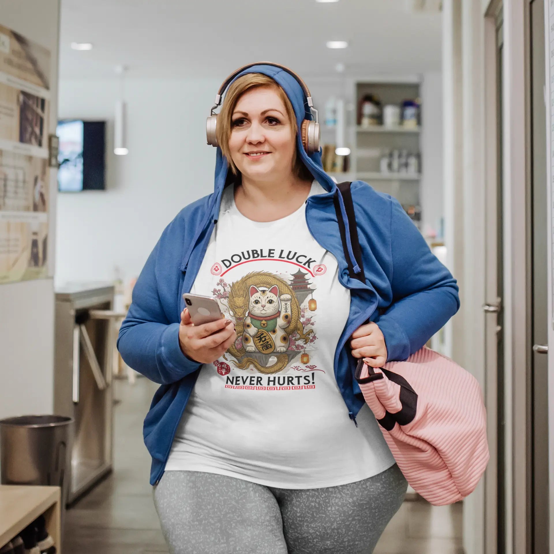 Model wearing Double Luck T-Shirt – unisex premium tee featuring Maneki-neko with Chinese lucky dragon, sakura blossoms, lanterns and Eastern motifs.