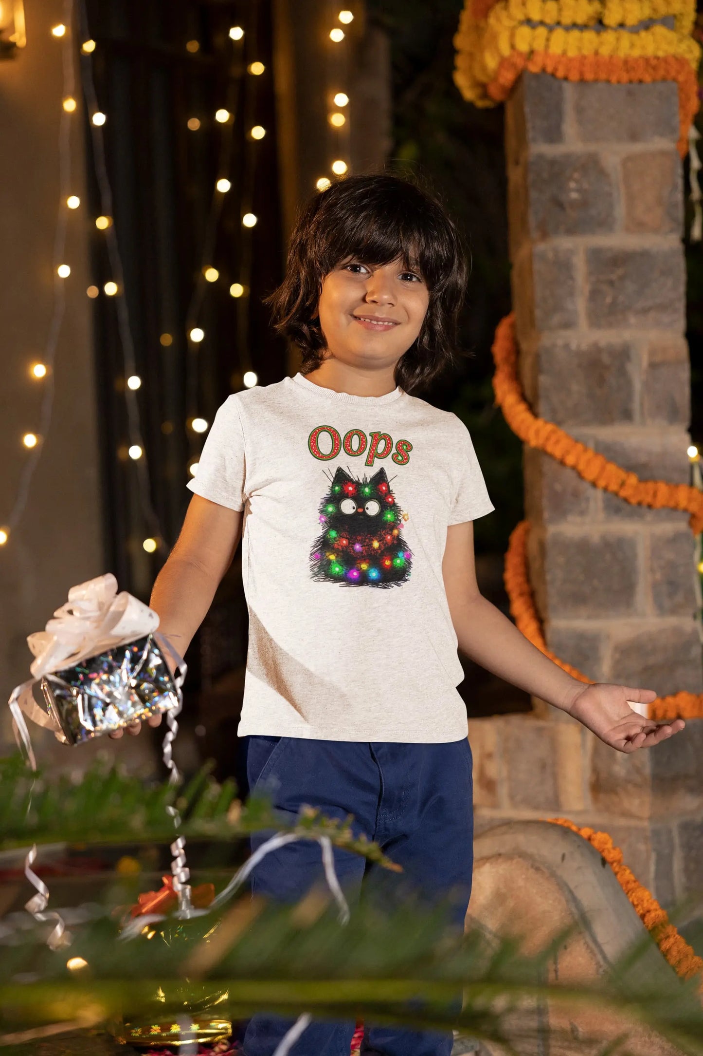 Model wearing Santa Claws Oops Funny Christmas Cat T-Shirt – unisex premium tee featuring black cat tangled in Christmas lights.