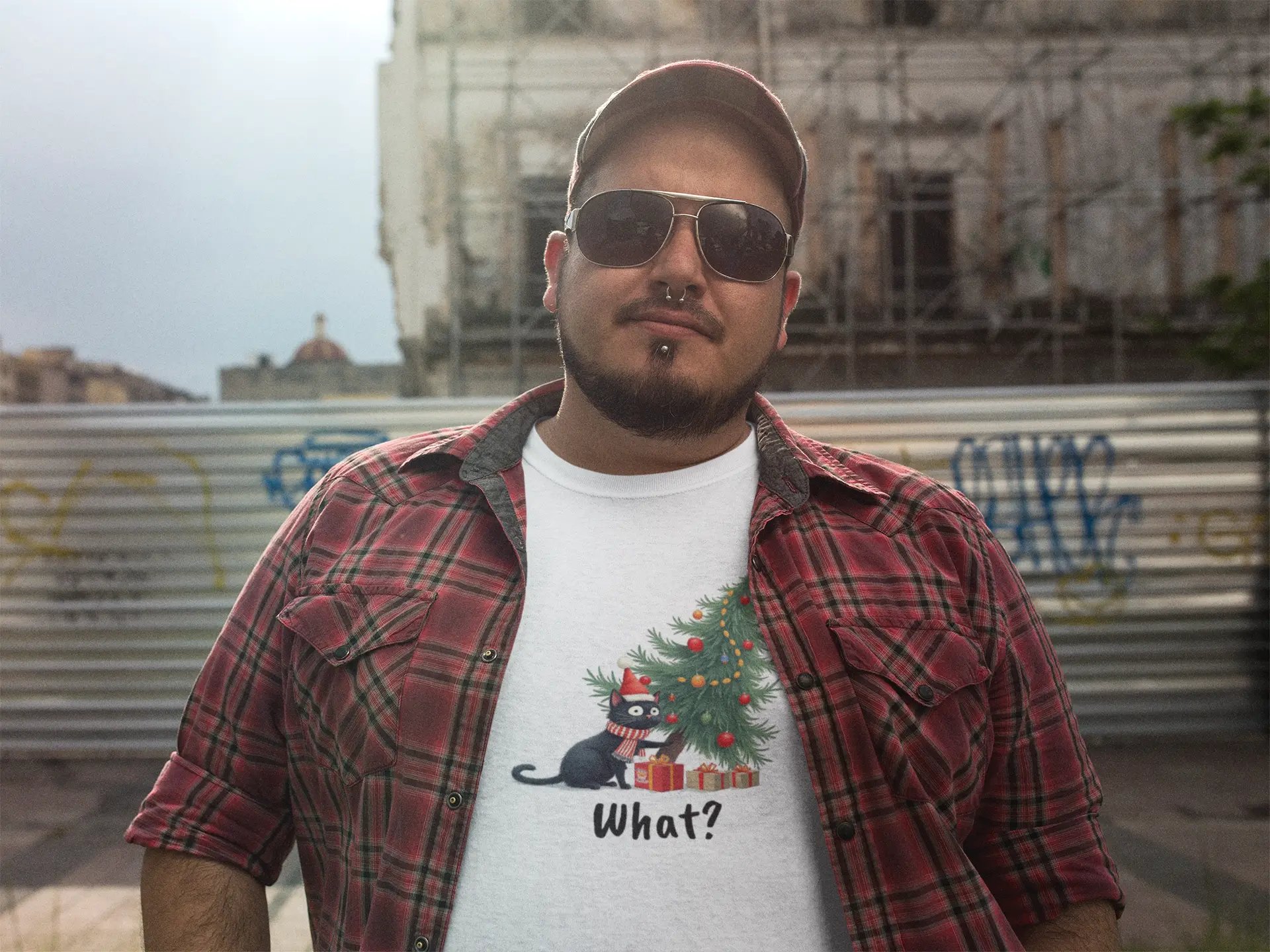 Model wearing Mission: Tree Impossible Funny Christmas Cat T-Shirt – unisex premium tee featuring black cat and falling Christmas tree.