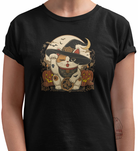 Close-up of Witchy Neko cat t-shirt print showing whimsical Maneki-neko with witch hat, candles, celestial symbols, and warm vintage colors