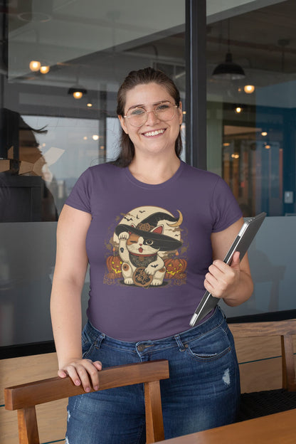 Model wearing classic women’s Witchy Neko Halloween t-shirt with artistic lucky cat design in orange, gold, and cream tones