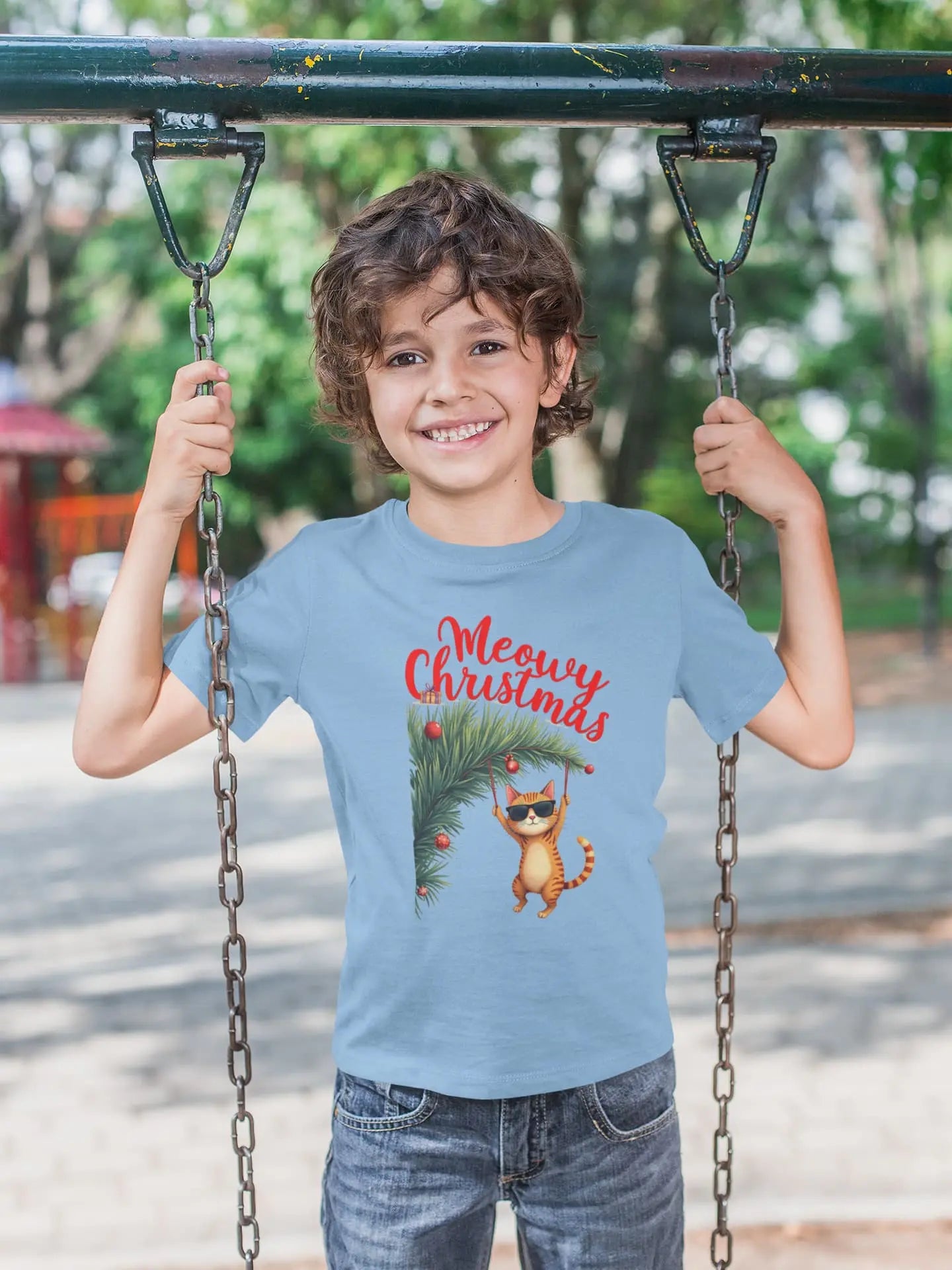 Model wearing Tree Diving Funny Christmas Cat T-Shirt – unisex premium tee featuring an orange cat in sunglasses hanging from a Christmas tree.