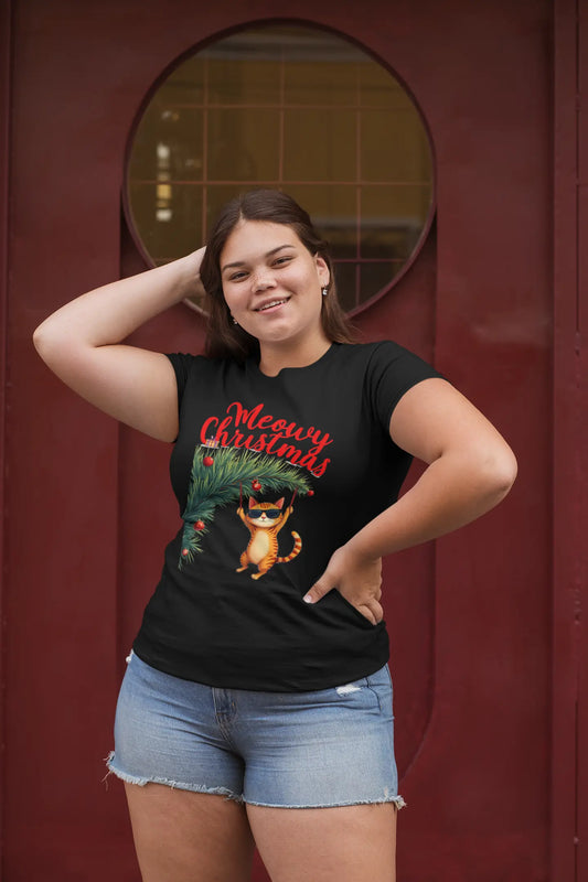 Model wearing Tree Diving Funny Christmas Cat T-Shirt – unisex premium tee featuring an orange cat in sunglasses hanging from a Christmas tree.
