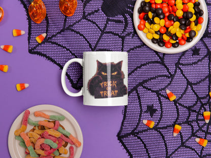 11oz ceramic mug Cursed Candy – mysterious cat with glowing Trick or Treat sign, part of Felinamia’s Meowlloween collection.