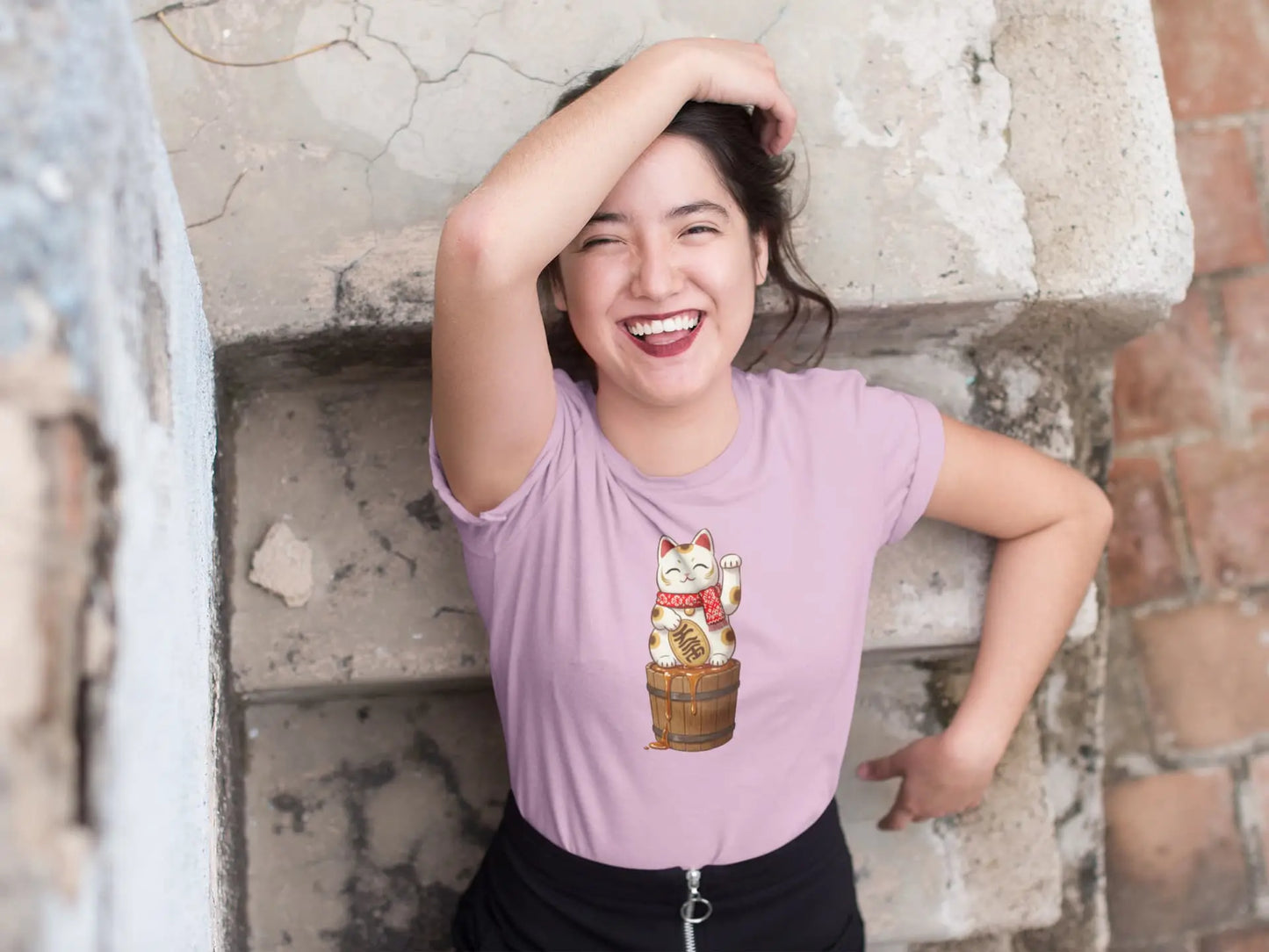 Person styling Lucky Maple Cat T-Shirt – playful Japanese lucky cat with scarf and maple syrup barrel, Canadian culture inspired.