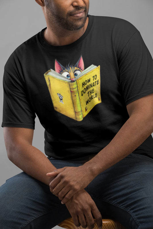 Model wearing How to Dominate the World Funny Conspirator Cat T-Shirt – unisex premium tee with clever cat reading book graphic.