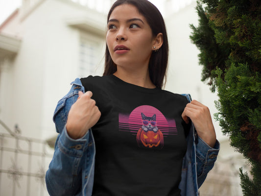 Model wearing Neon Pumpkin Cat T-Shirt – unisex premium tee featuring neon cat inside jack-o’-lantern with synthwave sunset.