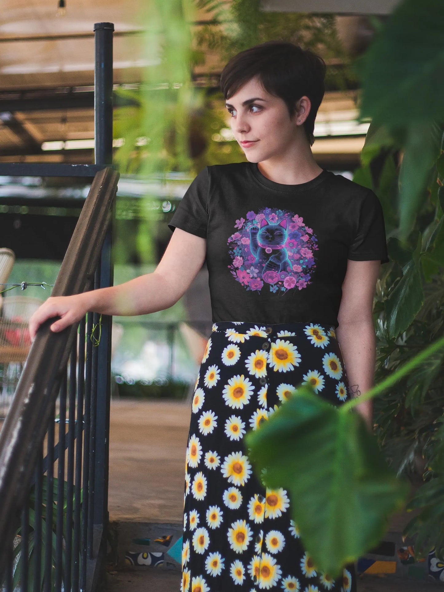 Model wearing the Maneki in Bloom cat t-shirt, featuring a floral Maneki Neko design with vibrant flowers and a stylish retro-futuristic spring aesthetic.