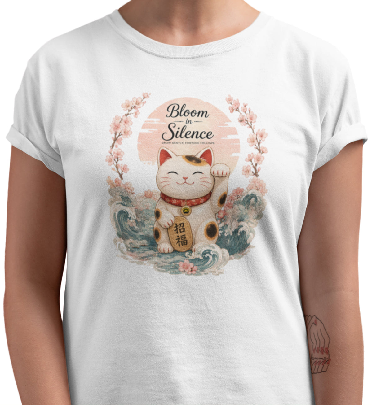 Bloom in Silence t-shirt featuring a smiling Maneki Neko surrounded by cherry blossoms and traditional Japanese waves.