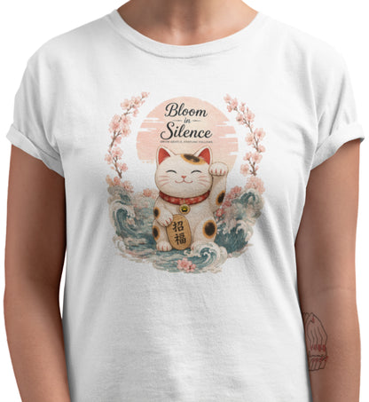 Bloom in Silence t-shirt featuring a smiling Maneki Neko surrounded by cherry blossoms and traditional Japanese waves.